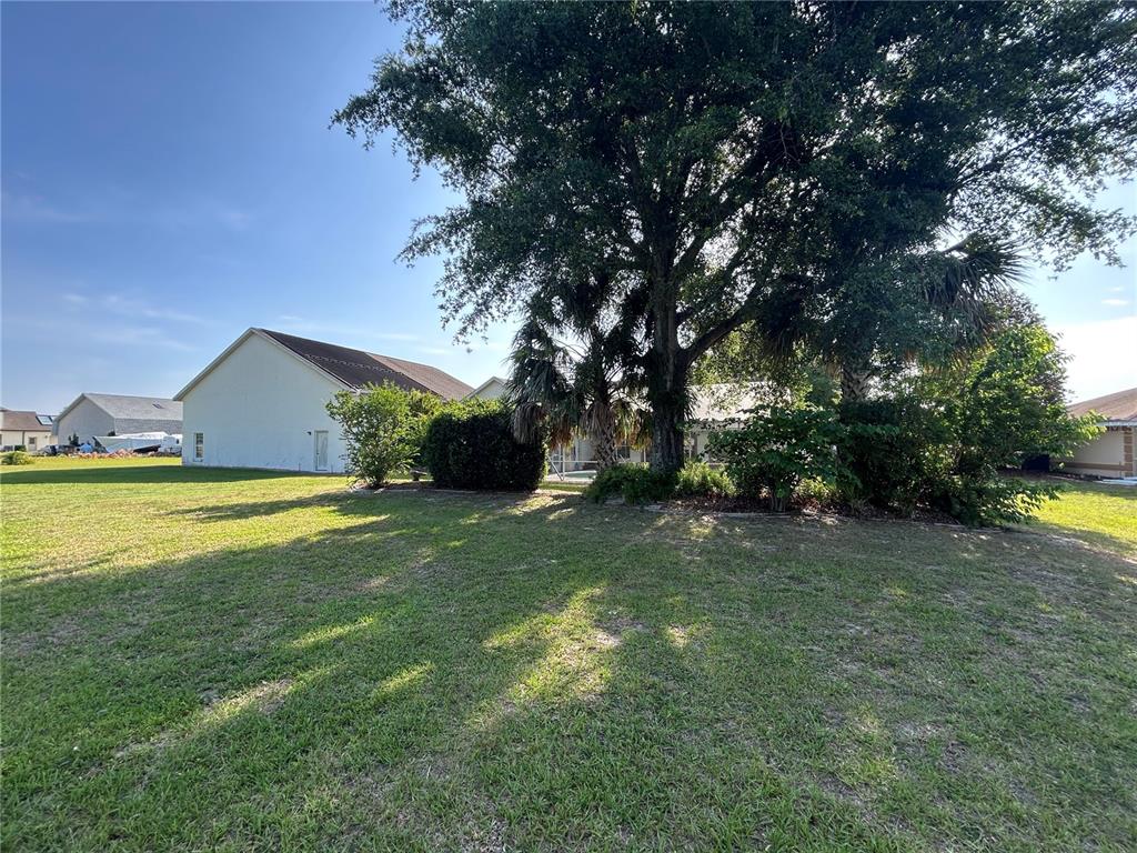 9528 Southeast 70th Terrace Ocala, FL 34472 - Photo 32 of 43 a view of an house with backyard space and swimming pool