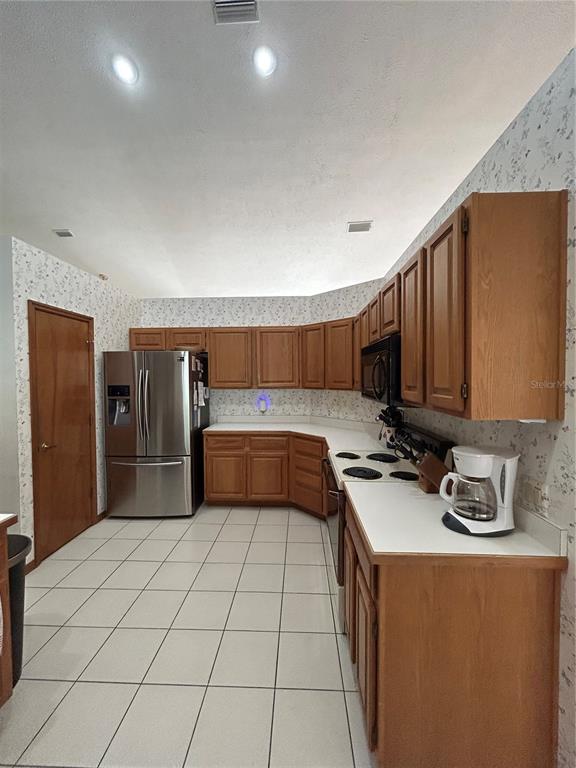 9528 Southeast 70th Terrace Ocala, FL 34472 - Photo 5 of 43 a kitchen with a sink a stove and a refrigerator