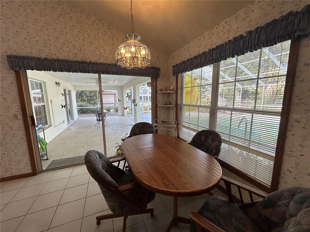 9528 Southeast 70th Terrace Ocala, FL 34472 - Photo 6 of 43 a living room with furniture and a chandelier