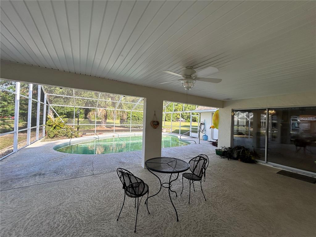 9528 Southeast 70th Terrace Ocala, FL 34472 - Photo 7 of 43 a dining room with furniture and a floor to ceiling window