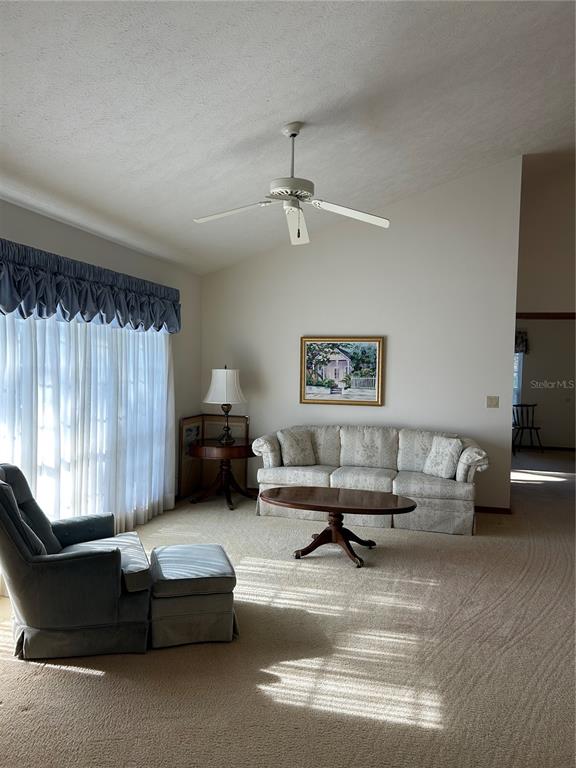 9528 Southeast 70th Terrace Ocala, FL 34472 - Photo 8 of 43 a living room with furniture and a window