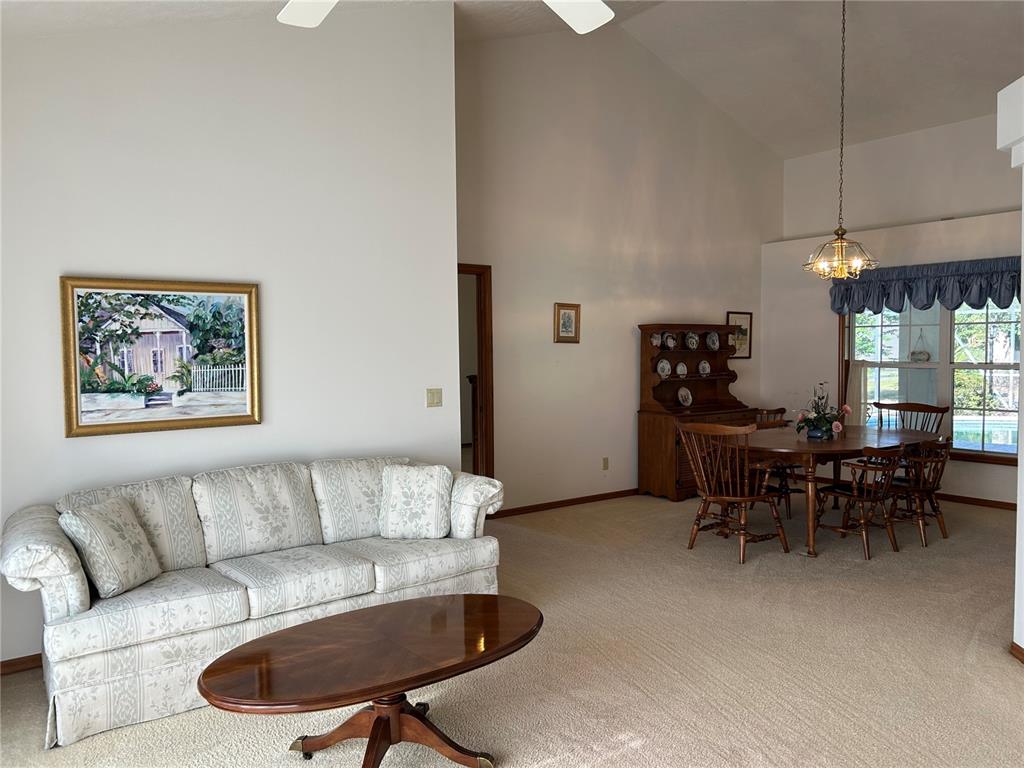 9528 Southeast 70th Terrace Ocala, FL 34472 - Photo 9 of 43 a living room with furniture a chandelier and a dining table