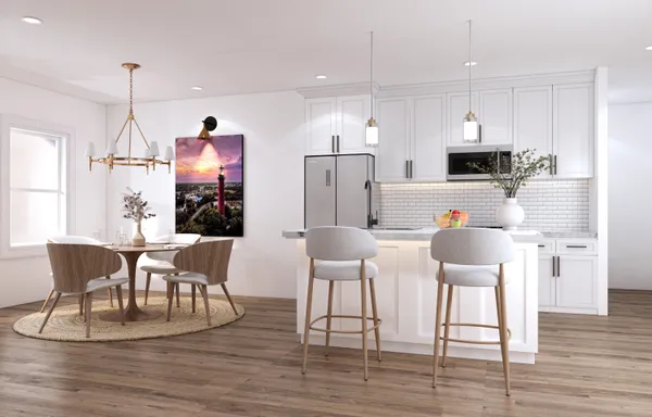 a kitchen with stainless steel appliances kitchen island granite countertop a dining table chairs and a refrigerator