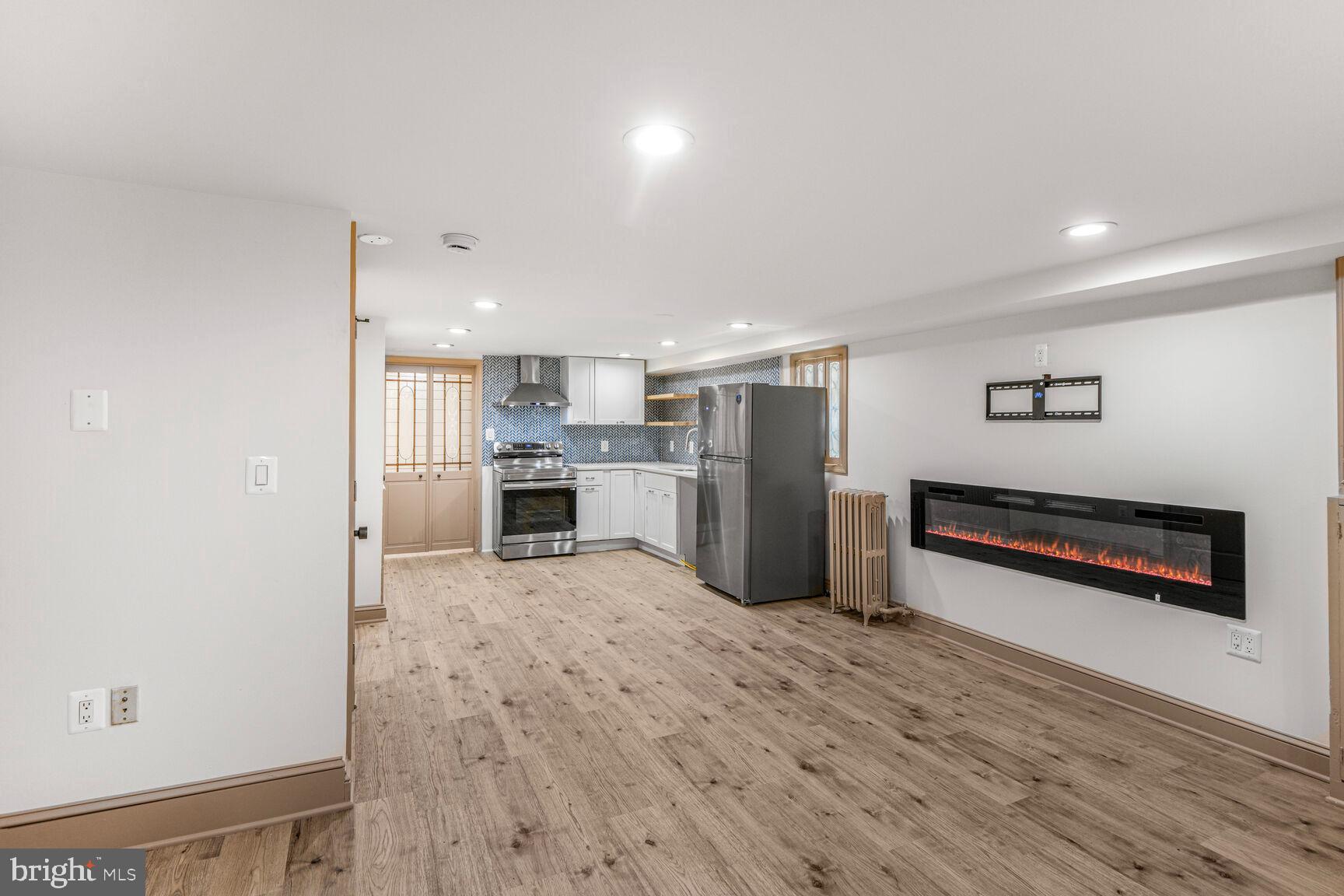 66 Bryant Street Northwest, Unit B Washington, DC 20001 - Photo 5 of 17 a kitchen with stainless steel appliances a refrigerator and a stove top oven
