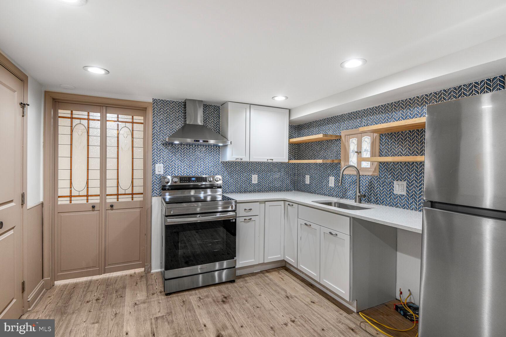 66 Bryant Street Northwest, Unit B Washington, DC 20001 - Photo 6 of 17 a kitchen with a stove and a refrigerator
