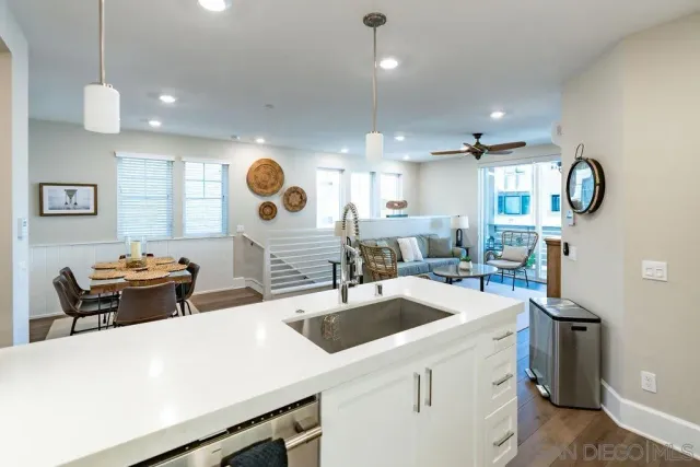 a kitchen with a sink a stove and chairs