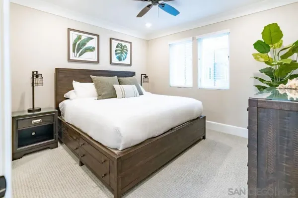 a bedroom with a bed and a potted plant