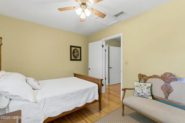 a bedroom with a bed and ceiling fan