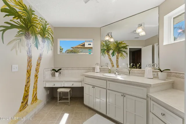 a bathroom with a double vanity sink and a mirror