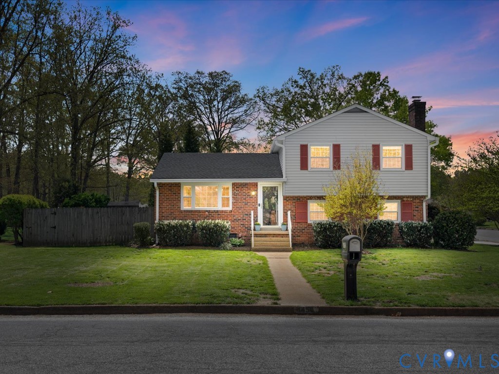 1455 Robindale Road Richmond, VA 23235 - Photo 1 of 29 a front view of a house with a yard and garage