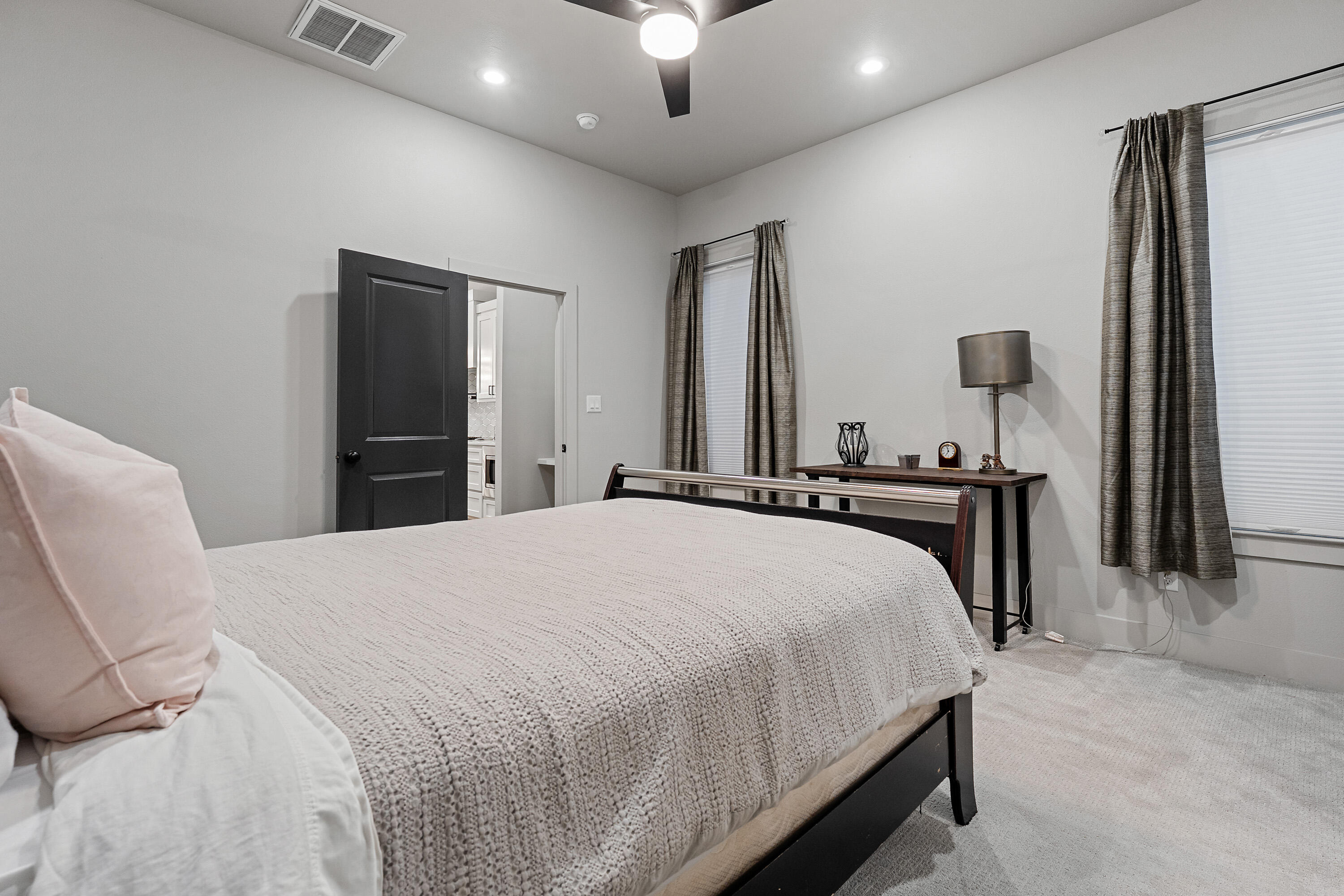 7814 55th Street Lubbock, TX 79407 - Photo 12 of 27 a bedroom with a bed and a chandelier