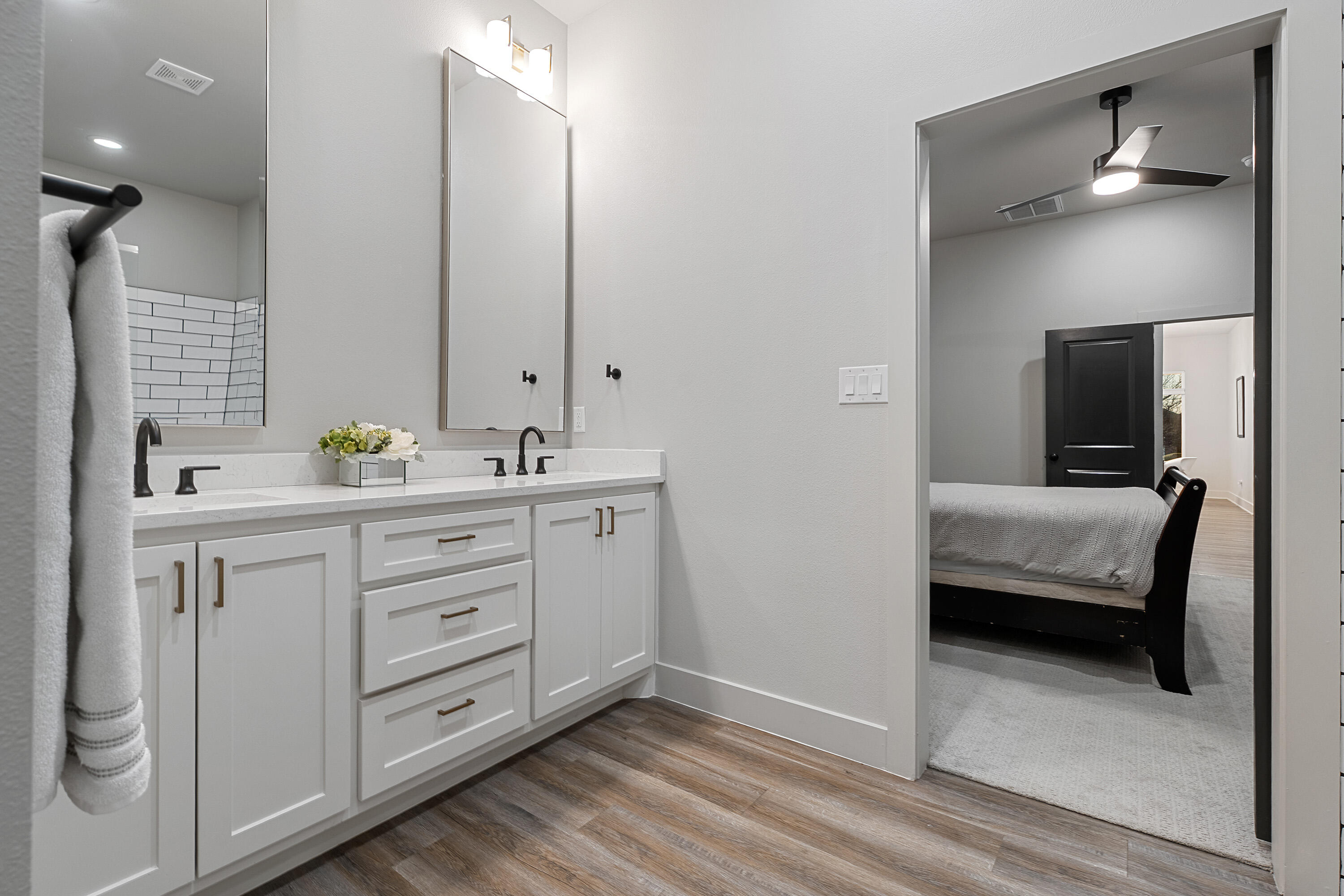 7814 55th Street Lubbock, TX 79407 - Photo 15 of 27 a bathroom with a double vanity sink a and mirror