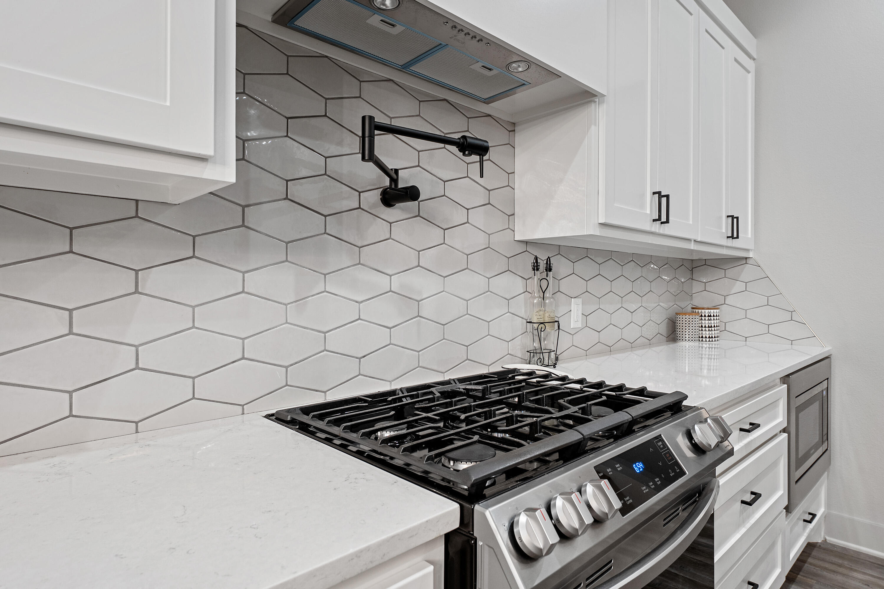 7814 55th Street Lubbock, TX 79407 - Photo 7 of 27 a stove top oven sitting inside of a kitchen
