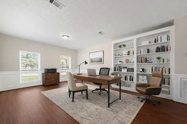 a workspace with furniture window and wooden floor