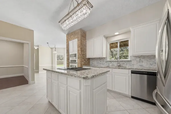 a kitchen with stainless steel appliances granite countertop a sink and dishwasher with wooden floor
