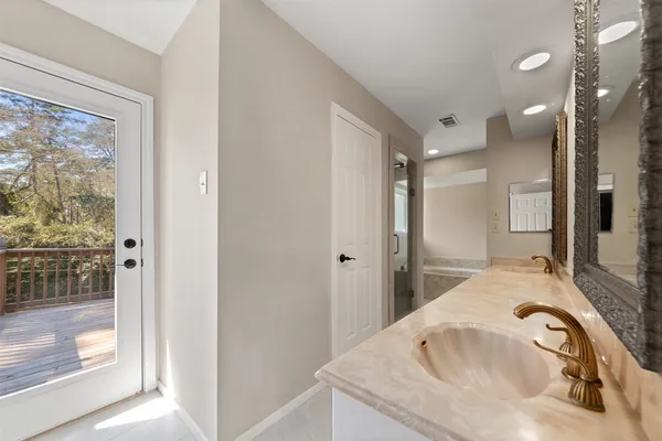 a bathroom with a granite countertop sink mirror and vanity