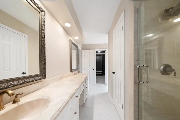 a bathroom with a tub sink and shower