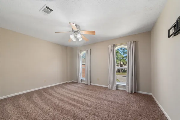 an empty room with windows and closet