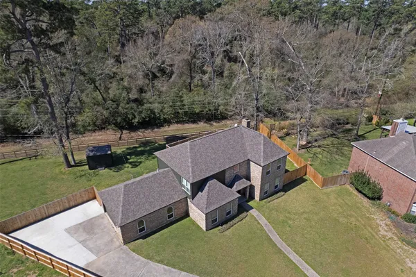 an aerial view of a house with garden space and a yard