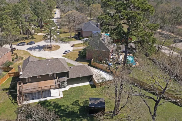 an aerial view of a house with garden space and street view