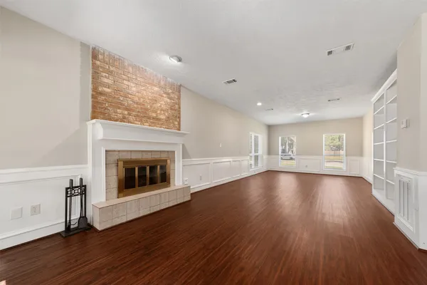 wooden floor in an empty room with a window