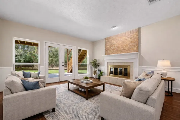 a living room with furniture and a fireplace