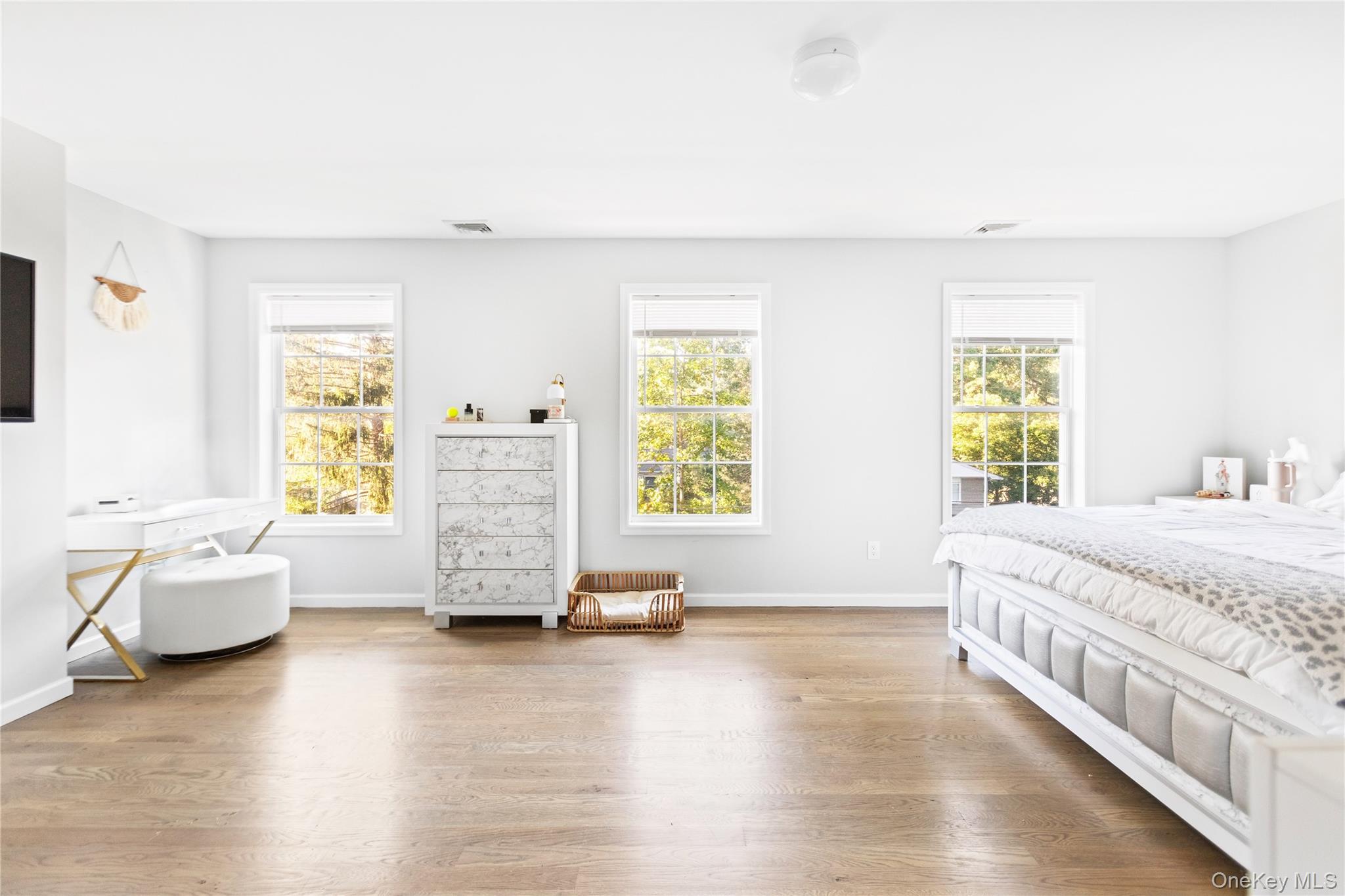 24 Belmont Road Sound Beach, NY 11789 - Photo 13 of 23 a spacious bedroom with a bed and wooden floor