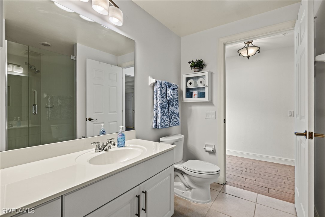 2745 First Street, Unit 1906 Fort Myers, FL 33916 - Photo 20 of 33 a bathroom with a toilet a sink and a mirror