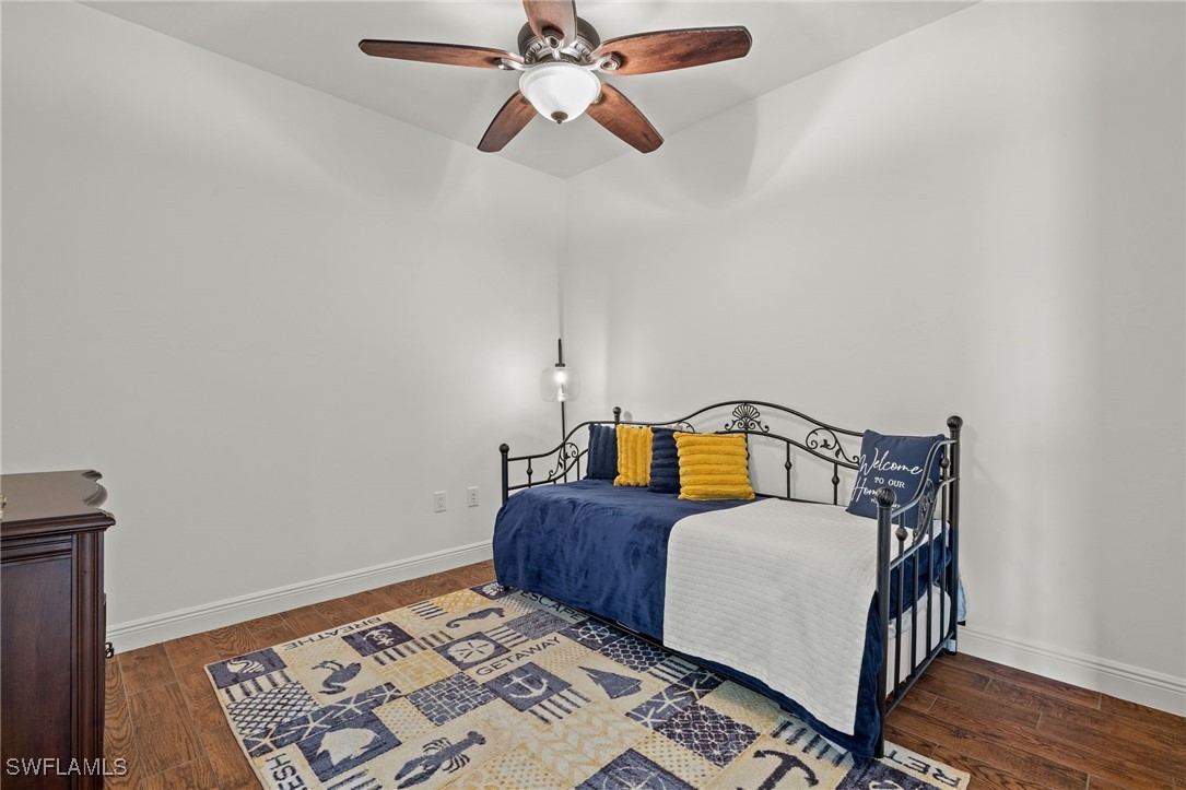 2745 First Street, Unit 1906 Fort Myers, FL 33916 - Photo 21 of 33 a bedroom with bed and wooden floor