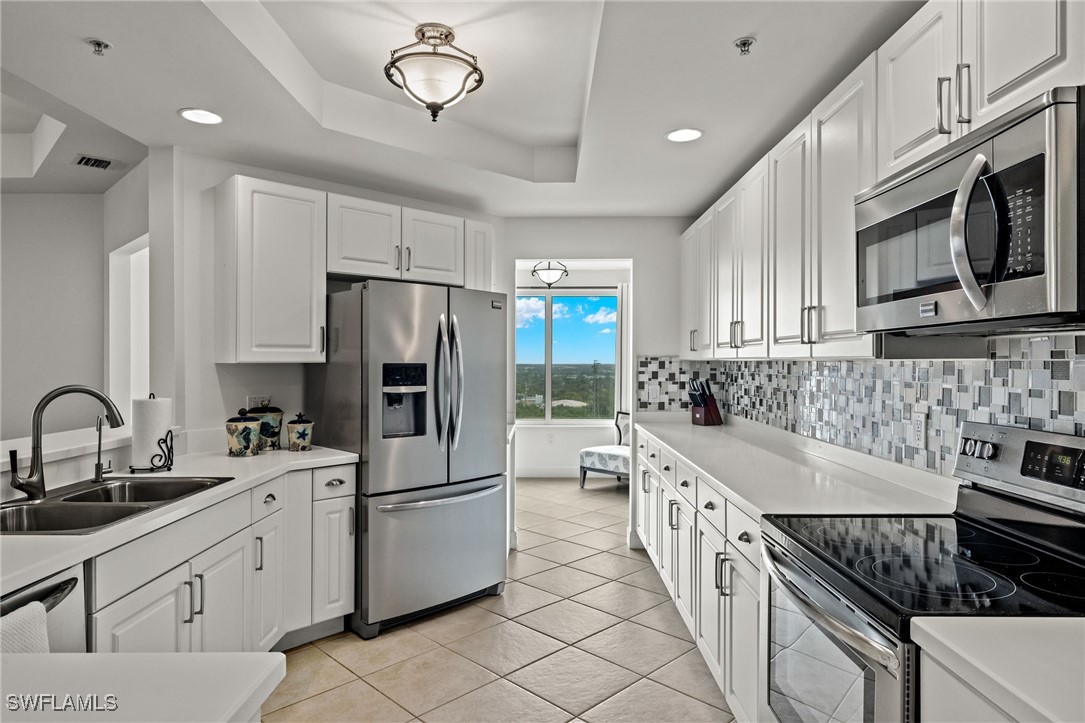 2745 First Street, Unit 1906 Fort Myers, FL 33916 - Photo 9 of 33 a kitchen with a sink stove and refrigerator