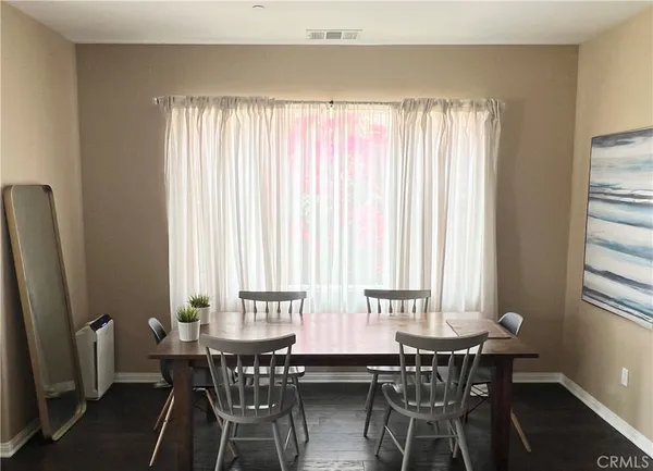 a view of a dining room with furniture and window