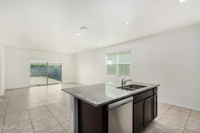 a kitchen with granite countertop a sink and a stove