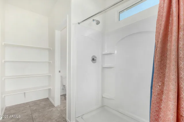 a bathroom with a glass shower door