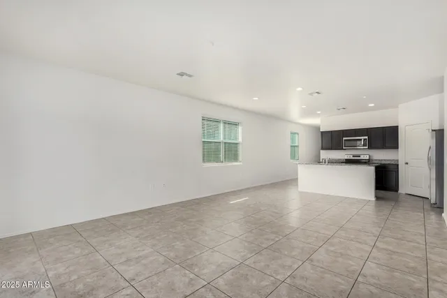 a view of kitchen with stainless steel appliances a refrigerator and a stove top oven