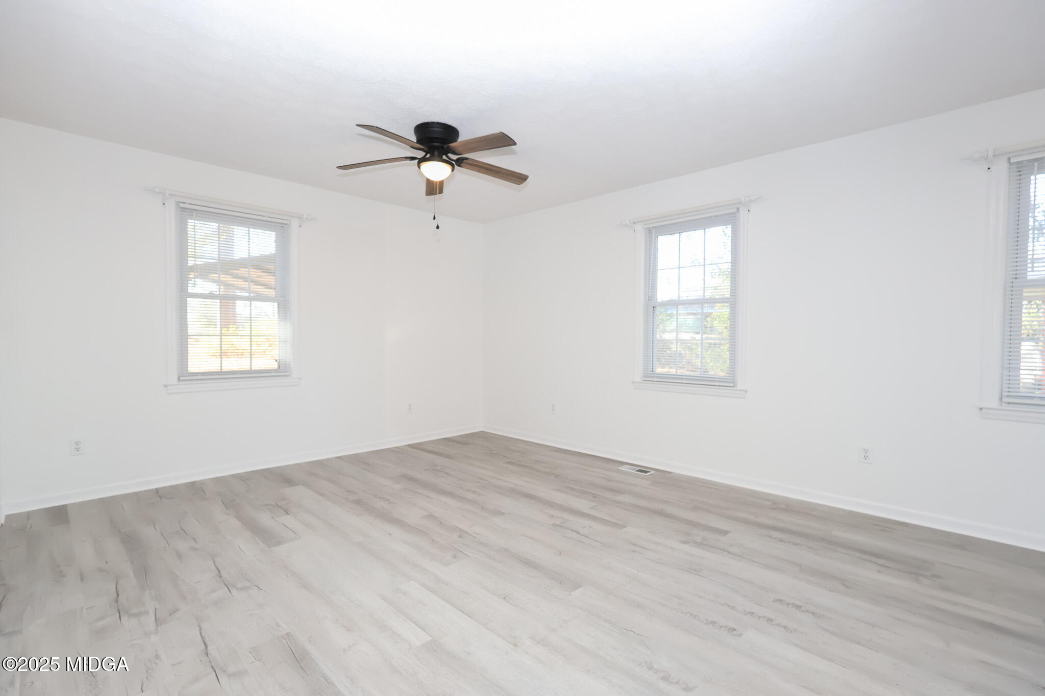 105 Larryton Drive Cochran, GA 31014 - Photo 15 of 34 a view of empty room with wooden floor and fan