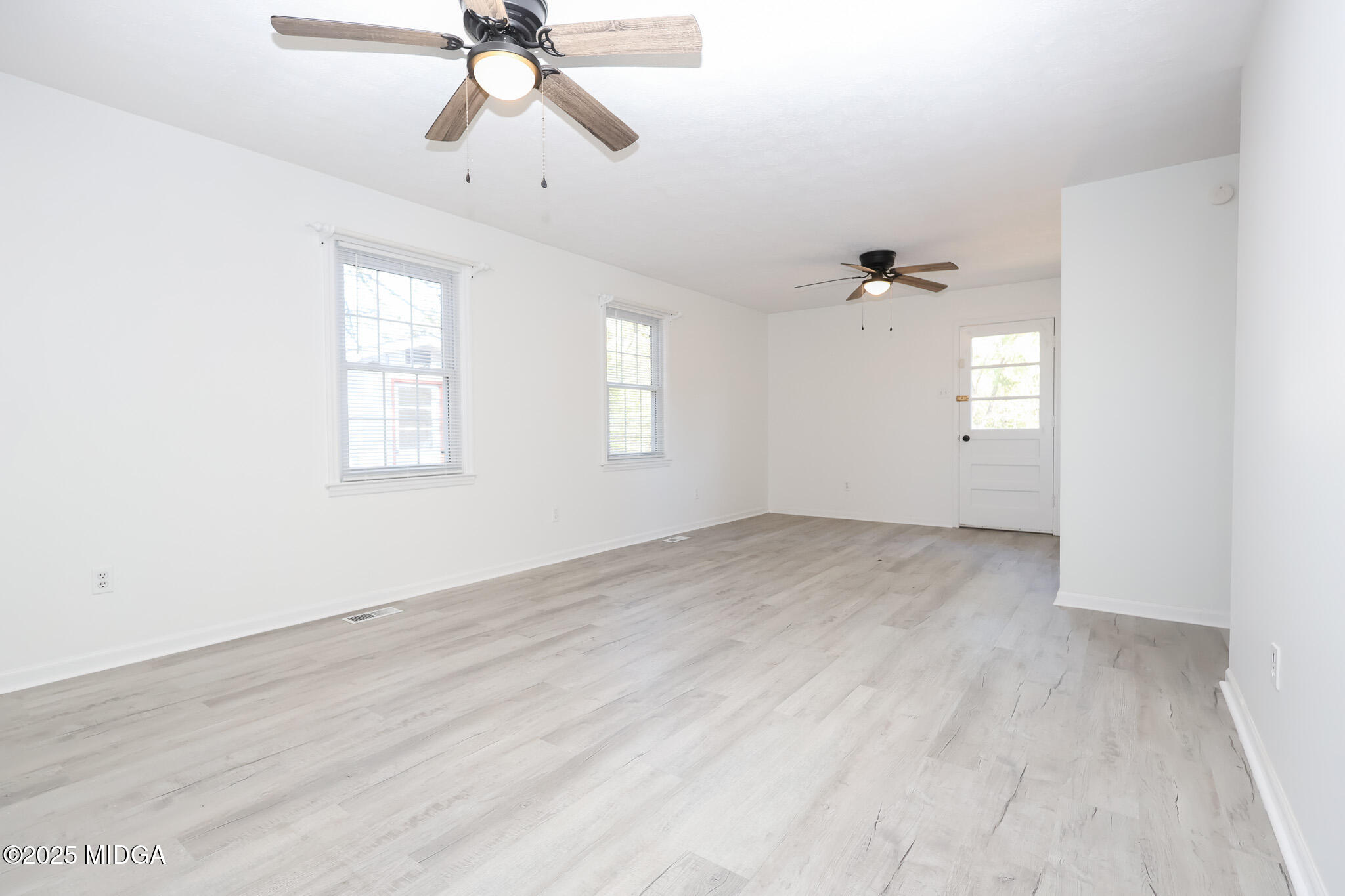 105 Larryton Drive Cochran, GA 31014 - Photo 17 of 34 wooden floor in an empty room with a window