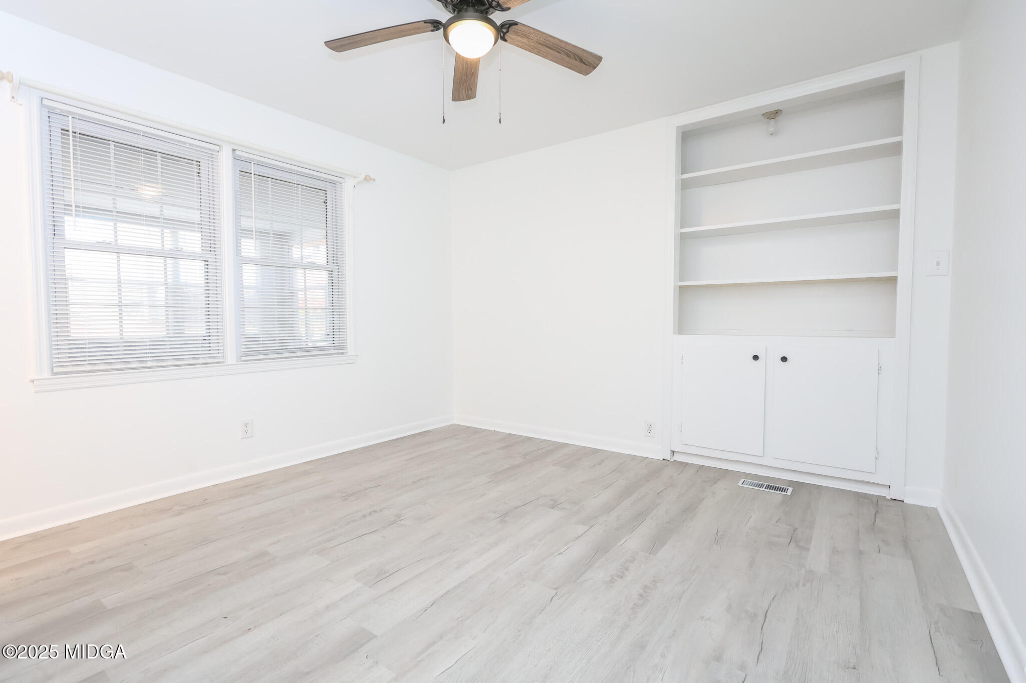 105 Larryton Drive Cochran, GA 31014 - Photo 19 of 34 wooden floor in an empty room with a window