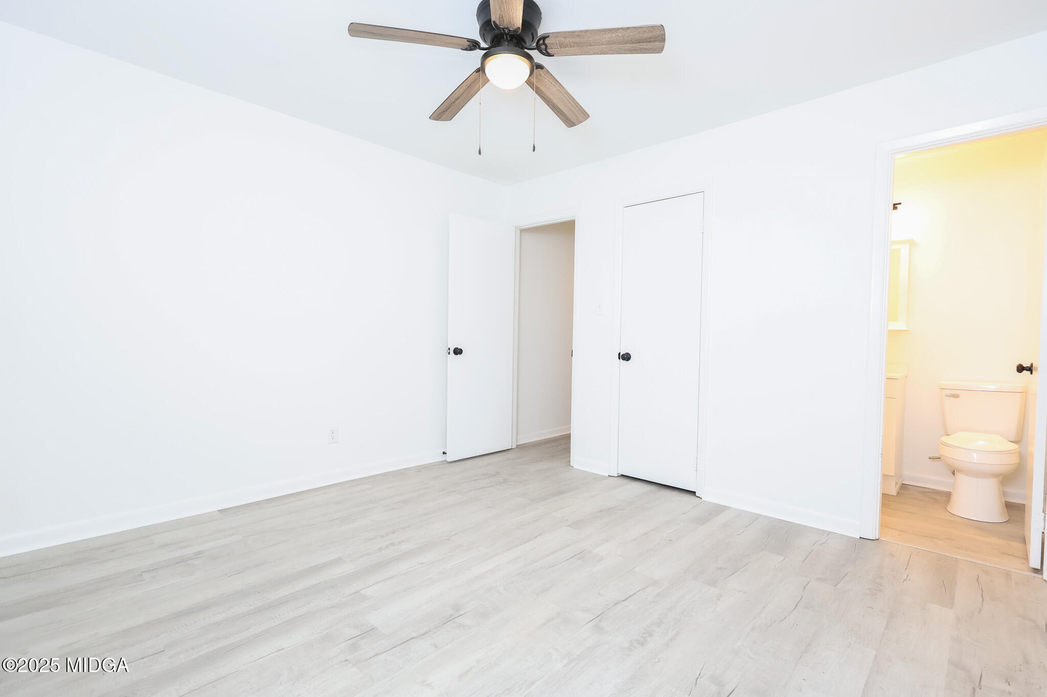 105 Larryton Drive Cochran, GA 31014 - Photo 20 of 34 a view of a room with wooden floor and a ceiling fan