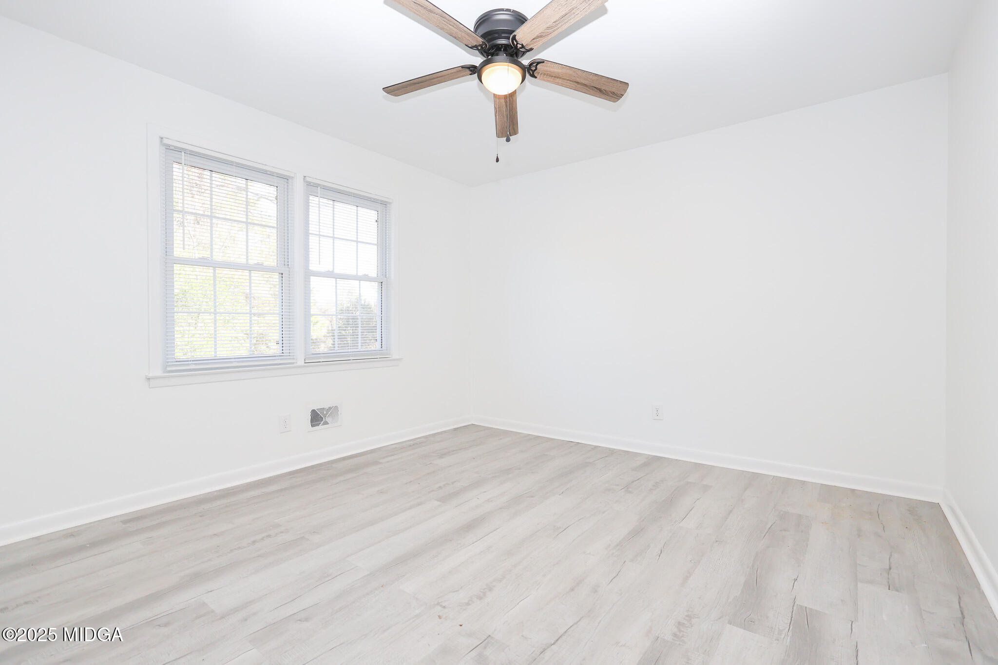 105 Larryton Drive Cochran, GA 31014 - Photo 22 of 34 an empty room with a window and a fan