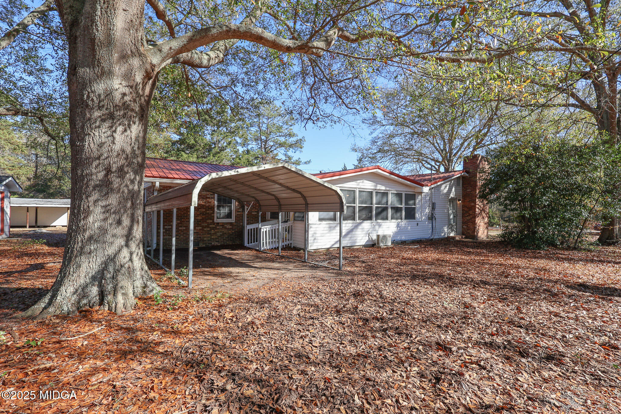 105 Larryton Drive Cochran, GA 31014 - Photo 31 of 34 a house with trees in front of it