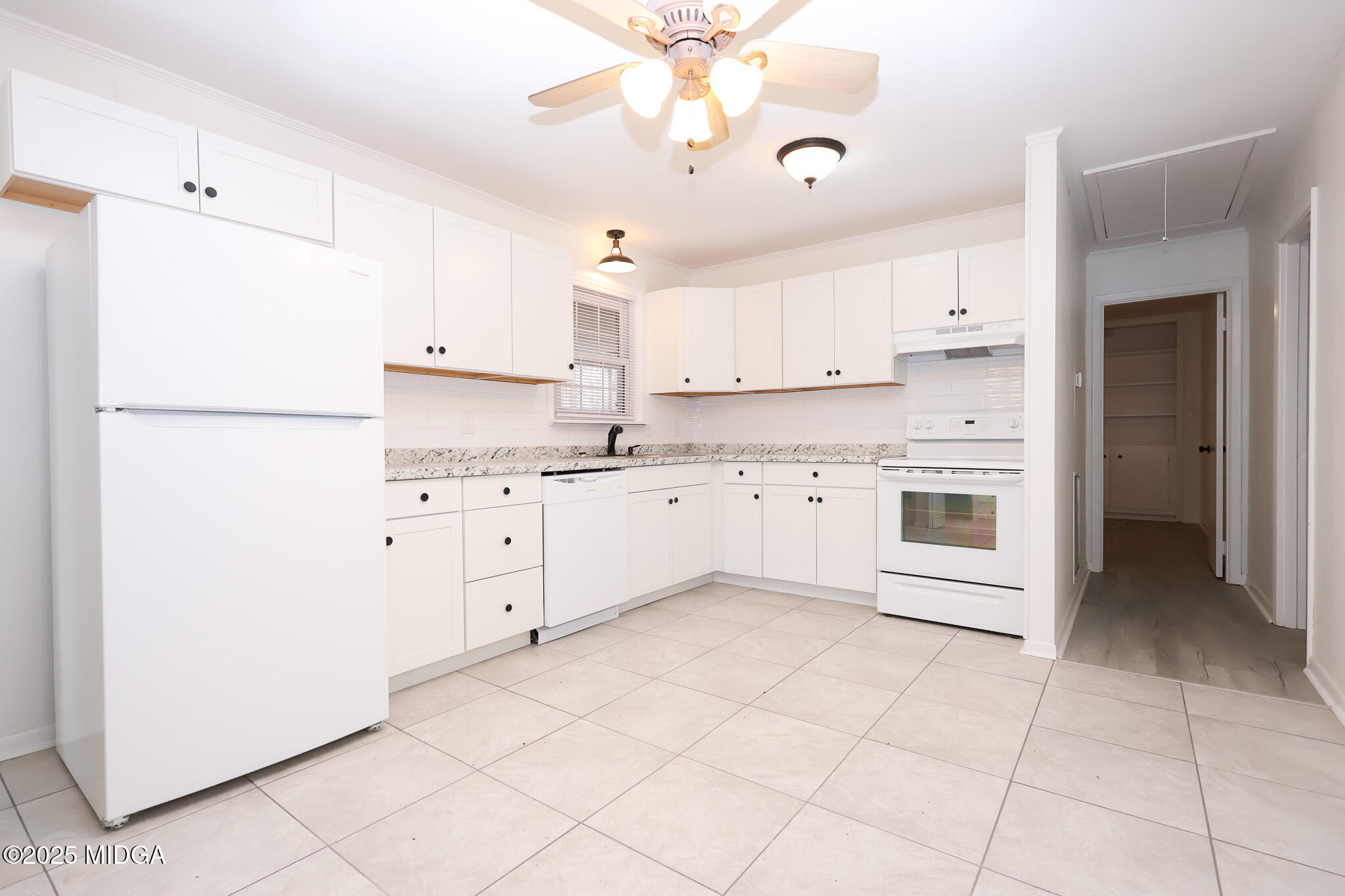 105 Larryton Drive Cochran, GA 31014 - Photo 8 of 34 a kitchen with cabinets and white appliances