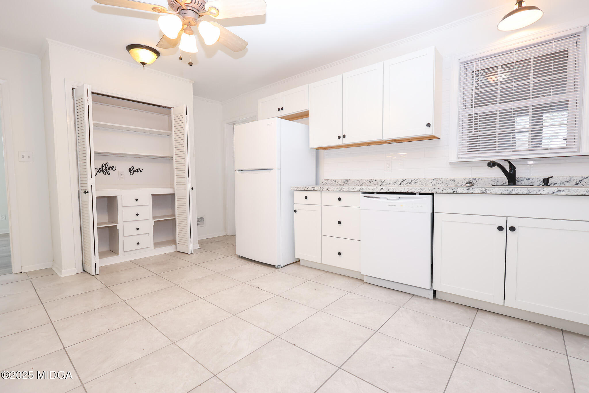 105 Larryton Drive Cochran, GA 31014 - Photo 9 of 34 a kitchen with granite countertop a sink cabinets and window
