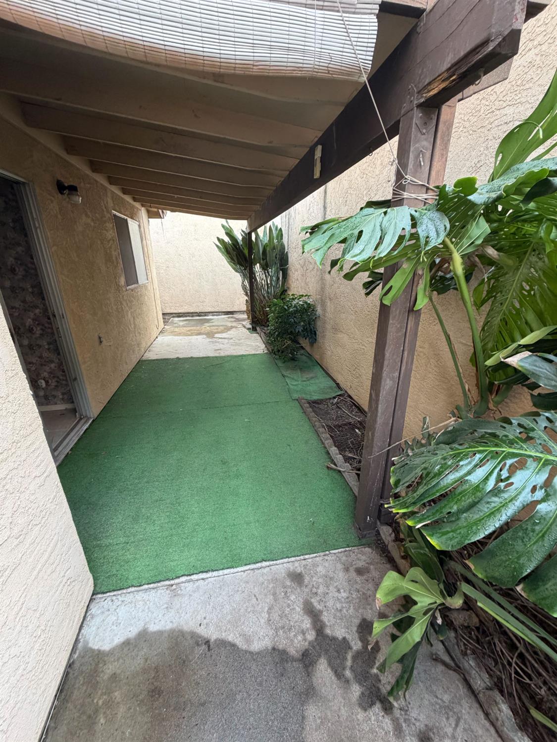536 Capistrano Drive Modesto, CA 95354 - Photo 16 of 18 a backyard with potted plants and a wooden bench
