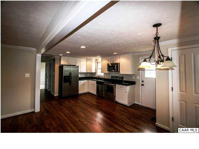 830 Ridge Street Charlottesville, VA 22902 - Photo 3 of 12 a kitchen with stainless steel appliances kitchen island granite countertop a refrigerator a sink dishwasher and a stove with wooden floor