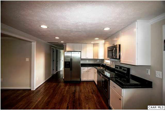 830 Ridge Street Charlottesville, VA 22902 - Photo 4 of 12 a kitchen with granite countertop stainless steel appliances a sink a stove a refrigerator a window