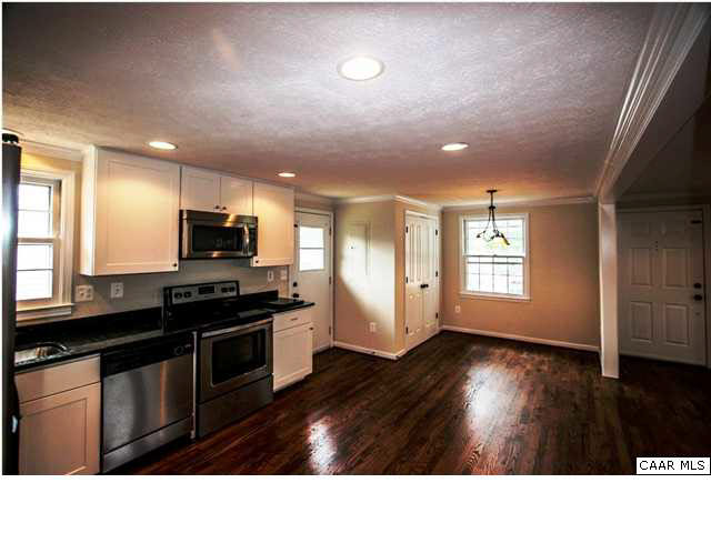 830 Ridge Street Charlottesville, VA 22902 - Photo 8 of 12 a kitchen with wooden floors and black appliances