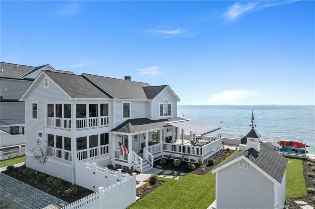 a view of a big house with a big yard and large tree