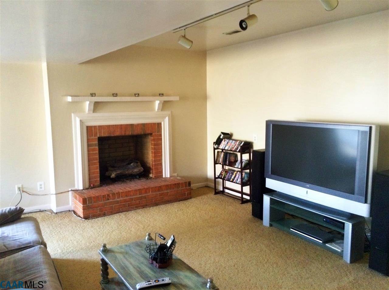 4354 Dickerson Road Charlottesville, VA 22911 - Photo 18 of 21 a living room with furniture and a fireplace