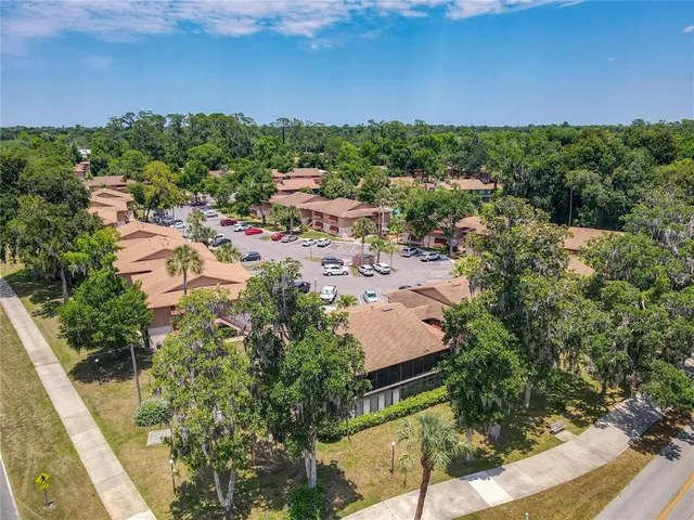 an aerial view of a house with pool garden and a yard