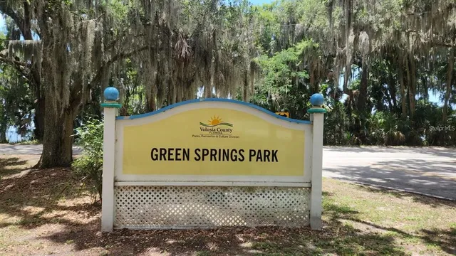 a view of balcony with wooden floor and fence